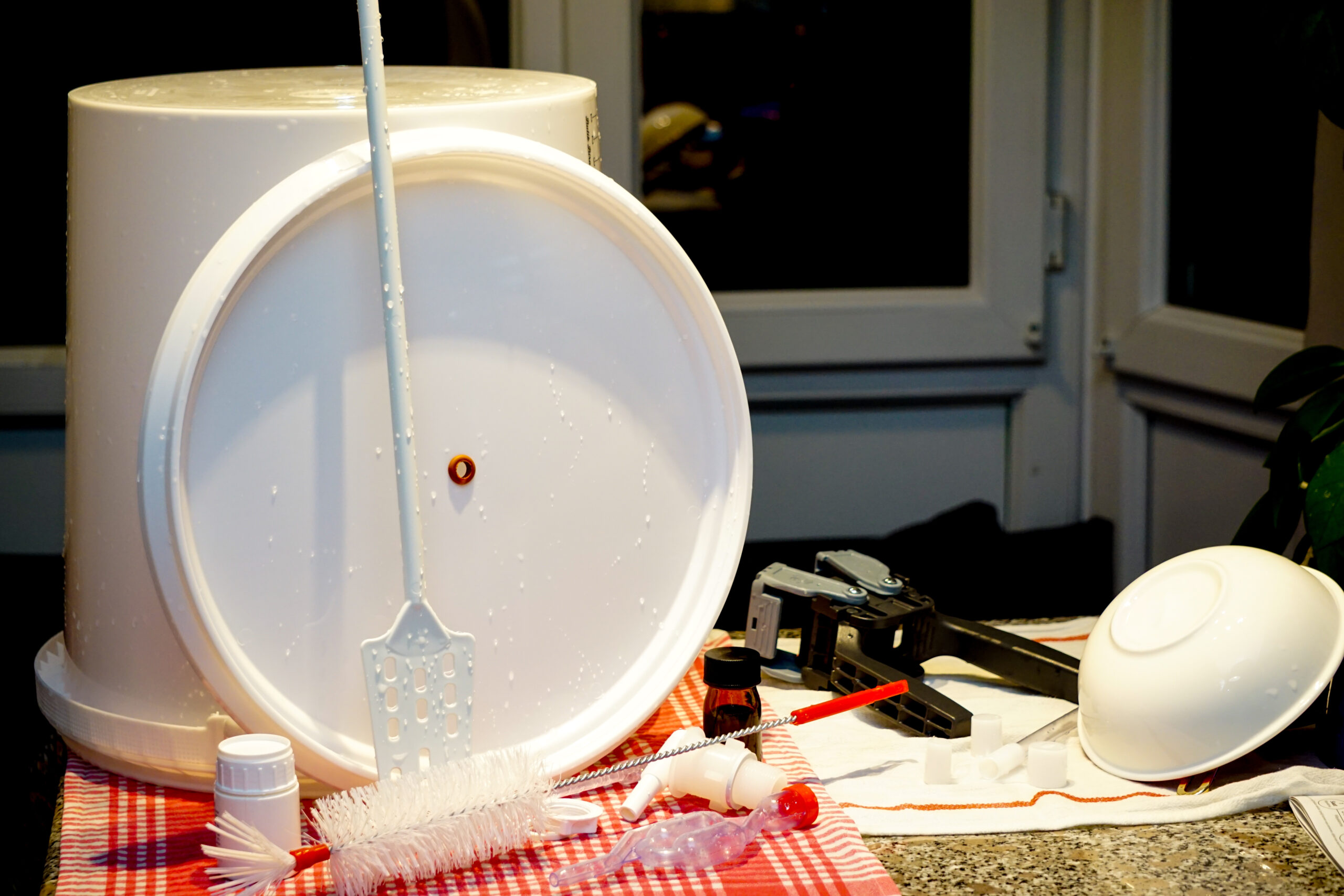 Brewing equipment drying on a clean towel.